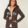 Holiday Vault Release Sherpa-Lined Zip-Up Logo Graphic Hoodie Holiday Vault Release Sherpa-Lined Zip-Up Logo Graphic Hoodie