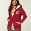 Holiday Vault Release Sherpa-Lined Zip-Up Logo Graphic Hoodie Holiday Vault Release Sherpa-Lined Zip-Up Logo Graphic Hoodie